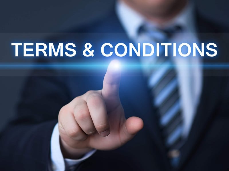 Terms and conditions text over a hand touching a screen